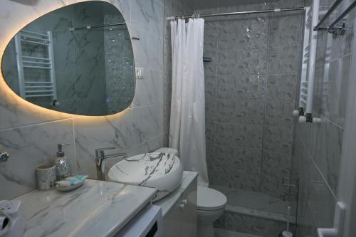 a bathroom with a sink and a toilet and a shower at JERUSALEM luks מלון Kutaisi in Kutaisi