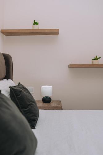 a bed with two plants on top of it at Comfy Apartment Near Acropolis in Athens