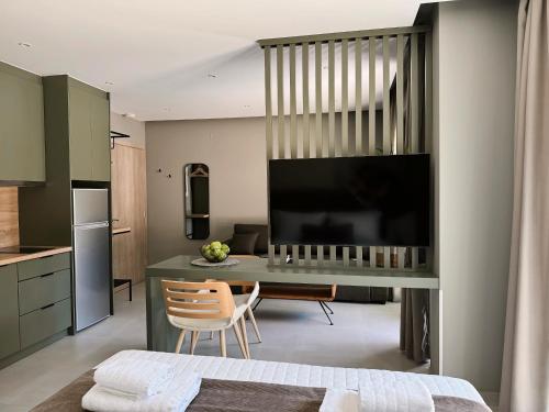 a kitchen with a desk with a large screen television at CHE BELLO NATURE in Preveza