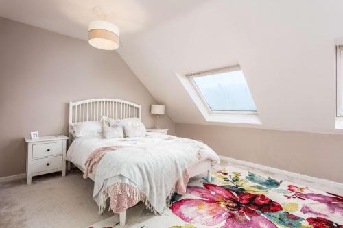 a white bedroom with a bed and a window at 56 Hawkhill Avenue in Ayr