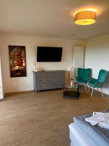 a living room with a flat screen tv on the wall at Ostseehaus Dreesen in Timmendorfer Strand