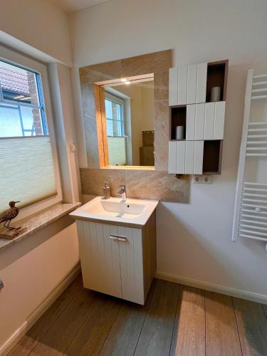 a bathroom with a sink and a mirror at Ostseehaus Dreesen in Timmendorfer Strand