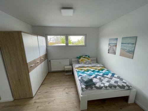 a small bedroom with a bed and a window at Herrliches Zweibett-Zimmer im Grünen in Schleswig-Holstein - ideal für Monteure, Gemeinschaftsbad Zimmer Nr 4 in Groß Vollstedt