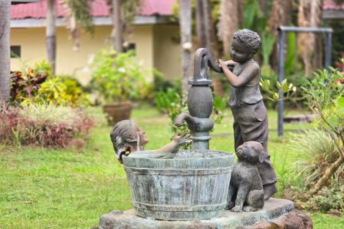 a statue of two children playing in a fountain at Grand Villa Laguna in Manila