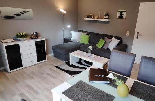 a living room with a couch and a table at Top Ferienwohnung am Diemelsee Sauerland in Diemelsee
