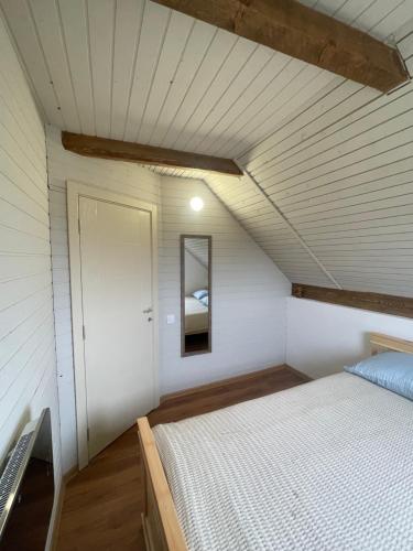a bedroom with a bed and a mirror at White House Žabljak in Žabljak