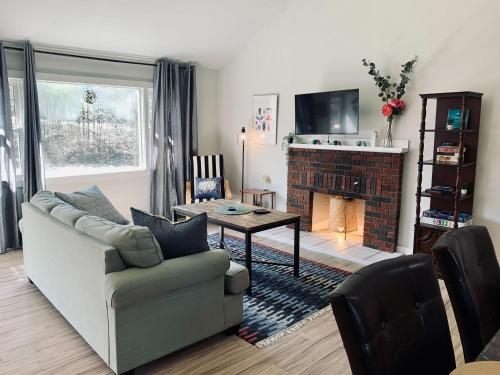 a living room with a couch and a fireplace at Serene Cottage in Halifax