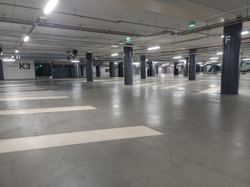 an empty parking garage with columns and lights at 18th Floor Helsinki High Point 1 BDR Apartment with City View - Free Garage Parking in Helsinki