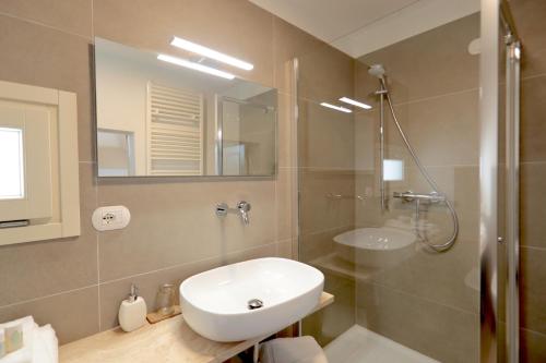 a bathroom with a sink and a toilet and a shower at Pietra Pesara in Locorotondo