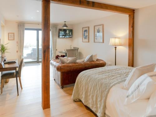 a bedroom with a bed and a chair and a desk at Askival Studio - Ukc6563 in Mallaig