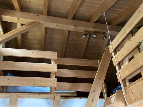a ceiling of a room with wooden walls and beams at Fravgia veglia in Andeer