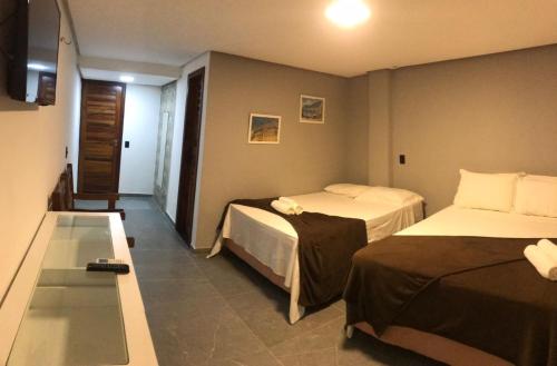 Ένα ή περισσότερα κρεβάτια σε δωμάτιο στο Milos Hotel Icaraizinho