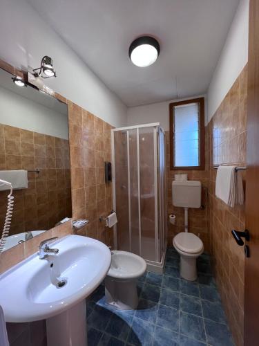 a bathroom with a sink and a toilet and a shower at African Beach Hotel-Residence in Manfredonia