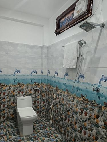 a bathroom with a shower and a toilet at Hotel Tejas in Gupta Kāshi