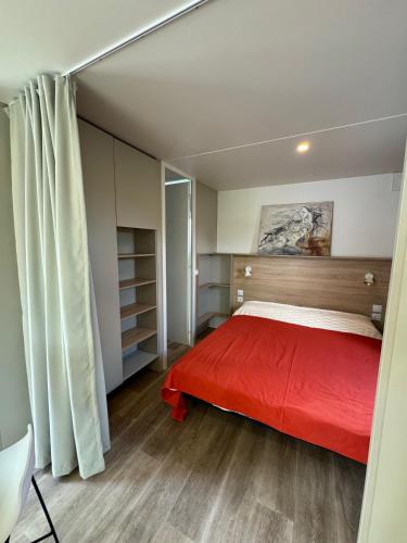 a bedroom with a bed with a red blanket at Palazzo delle Biscie - Old Tower & Village in Molinella