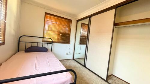 - une petite chambre avec un lit et une fenêtre dans l'établissement Greenhill Rockhampton, à Rockhampton