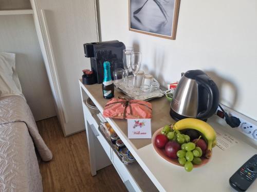 a kitchen counter with a bowl of fruit on it at Il Paradiso del Relax Chambres d'hotes Affittacamere room with sea view in Sanremo