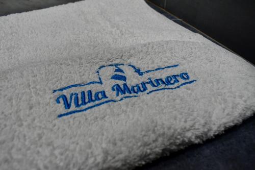 a white towel with a logo on it at Villa Marinero in Ulcinj