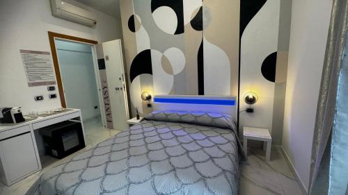 a bedroom with a bed with a blue head board at Cagliari Love Suite in Cagliari