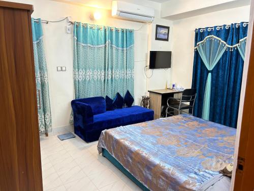 a bedroom with a blue bed and a blue chair at ASIF's Residence In Newmarket in Dhaka