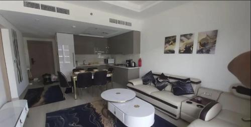 a living room with a couch and a table at Luxury Apartment in Central Dubai in Dubai