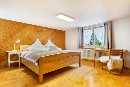 a bedroom with a bed and a wooden wall at Ferienwohnung zum Pavillon in Mühlenbach