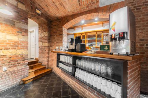 a bar in a brick wall with a counter and stairs at EA Hotel Victoria in Prague