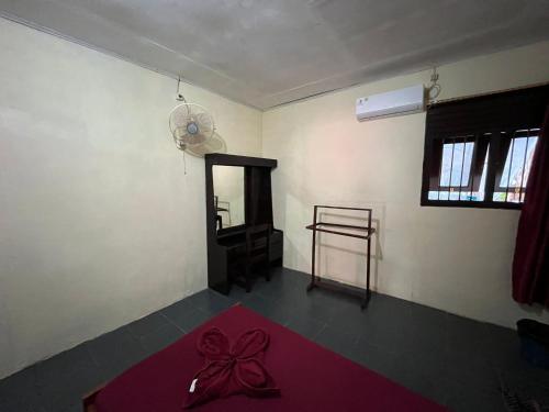 a room with a bow on the floor of a room at EL Homestay Bunaken in Bunaken