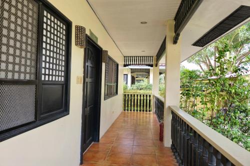 a hallway of a house with a door and a balcony at Grand Villa Laguna in Manila