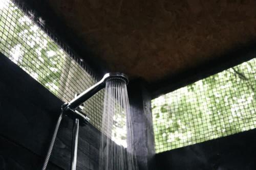 a shower with a shower head in a bathroom at Eisa Yurt in York