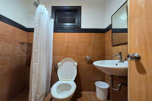 a bathroom with a toilet and a sink at Grand Villa Laguna in Manila