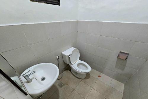 a bathroom with a toilet and a sink at Grand Villa Laguna in Manila