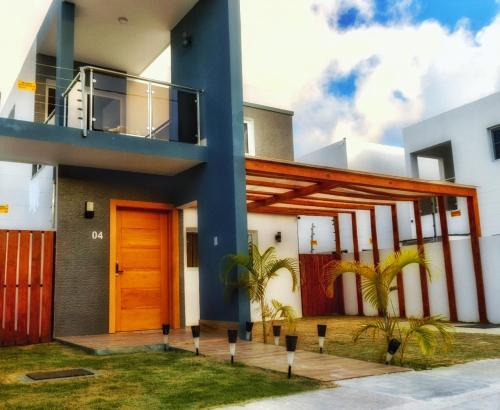 a house with a orange door and a balcony at Villa Sian in Punta Cana