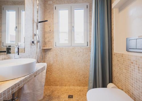 a bathroom with a sink and a toilet at Blue Domus in Cagliari