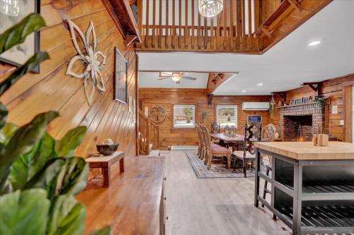 a living room with wooden walls and a dining room at Cabin in Long Pond Gameroom Pool Table in Long Pond