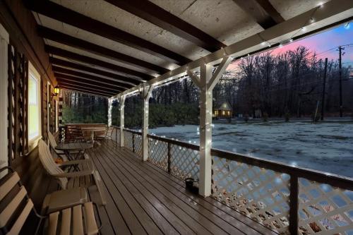 a porch with chairs and a view of the snow at Cabin in Long Pond Gameroom Pool Table in Long Pond
