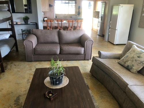 a living room with a couch and a table at Sanctuary Life Guest Farm in Magaliesburg