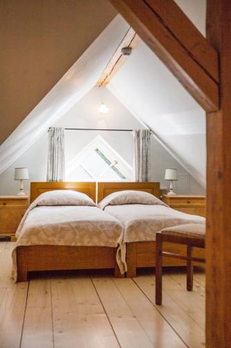a bedroom with a bed with a large window at Villa Titina in Miedzygorze