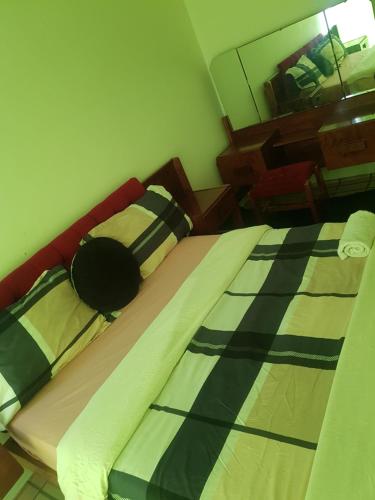 a bedroom with two beds and a mirror at Salvador Building in Vereeniging