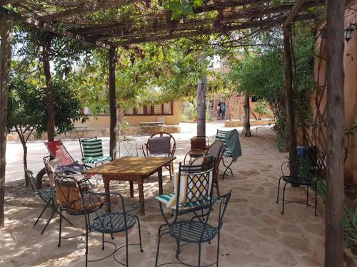 un patio con mesa y sillas bajo una pérgola en Azzaouia Resort, en Tahla