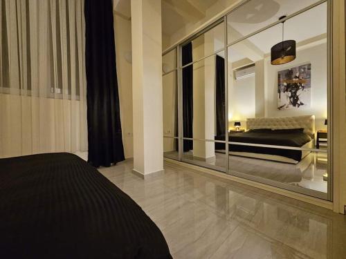 a bedroom with a mirror and a bed in a room at Merter Apartments in Kavadarci