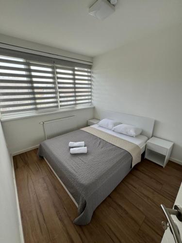 a bedroom with a bed with two towels on it at XL Apartman in Teslić