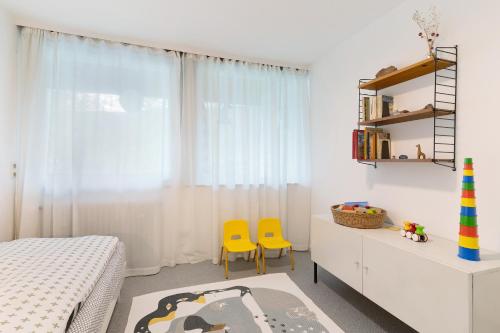 a bedroom with a bed and two yellow chairs at Haus Erika in Alpirsbach