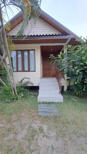 a small house with stairs in front of it at Apache Bar Haad yao in Haad Yao