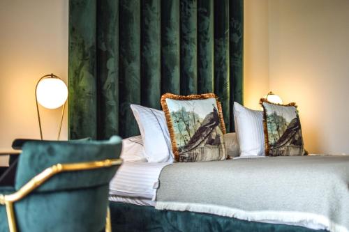a bedroom with a bed and a chair at Golden Rooms in Ioannina