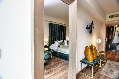 a hotel room with a bed and a mirror at Golden Rooms in Ioannina
