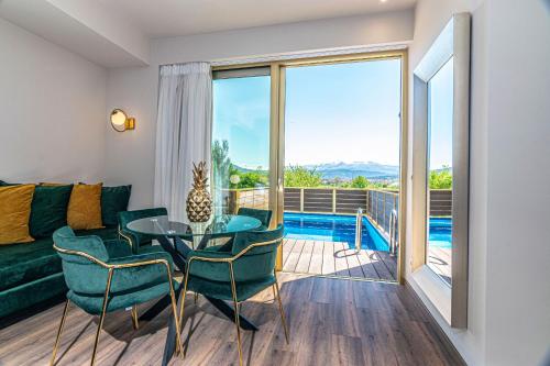 a living room with a couch and a table and chairs at Golden Rooms in Ioannina