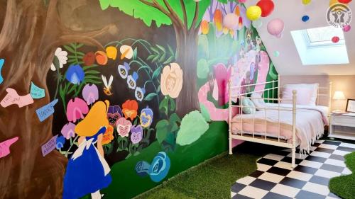 a childs bedroom with a mural of flowers at Le Terrier d Alice et du lapin in Floyon