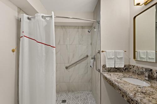 a bathroom with a shower and a sink at Red Roof Inn Carson - Wilmington, CA in Wilmington