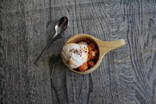 a bowl of food on a table with a spoon at Olarsgården Hotell in Lindvallen